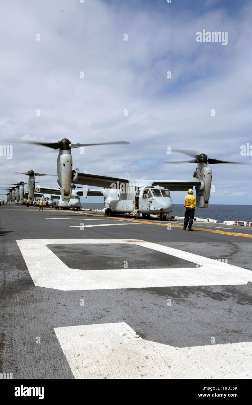 Eight U.S. Marine Corps MV-22B Ospreys prepare for liftoff during flight operations on the USS Bonhomme Richard (LHD 6), at sea, March 14, 2015. The Ospreys are with Marine Medium Tiltrotor Squadron (VMM) 262 (Reinforced), 31st Marine Expeditionary Unit (MEU). VMM-262 (REIN) is the aviation combat element for the 31st MEU. The 31st MEU is participating in amphibious integration training with the Bonhomme Richard Amphibious Ready Group during their Spring Patrol of the Asia-Pacific region. (U.S. Marine Corps photo by Staff Sgt. Joseph DiGirolamo/Released) Ospreys Transport Marines to Airfield S Stock Photo