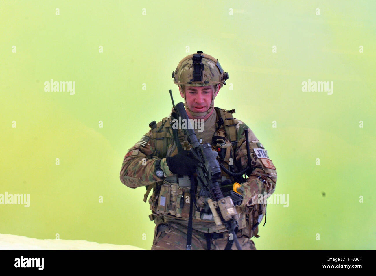 Tech. Sgt. Brandon Gilbert, a Joint Terminal Attack Controller (JTAC), crosses the enemy danger using smoke bombs to move more covertly to his observation rally point (ORP) during a training exercise at Fort Drum, N.Y.,  March 14, 2015. Thirty Airmen from the New York Air National Guard’s 274th Air Support Operations Squadron (ASOS) participated in Close Air Support (CAS) training that enhances their ability to identify a target and neutralize a threat. The 274th mission is to advise U.S. Army commanders on how to best utilize U.S. and NATO assets for Close Air Support. (New York Air National  Stock Photo