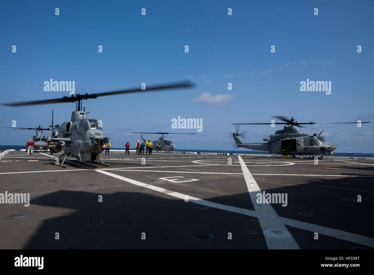 U.S. Marine Corps UH-1Y Hueys and AH-1 Super Cobras assigned to Marine Medium Tiltrotor Squadron 262 (Reinforced), 31st Marine Expeditionary Unit (MEU), prepare to take off from the flight deck of the USS Green Bay (LPD 20) while out at sea, March 11, 2015. The 31st MEU is currently conducting its Spring Patrol of the Asia-Pacific region. (U.S. Marine Corps photo by GySgt Ismael Pena/Released) VMM 262 (Rein) aboard the USS Green Bay 150314-M-CX588-032 Stock Photo
