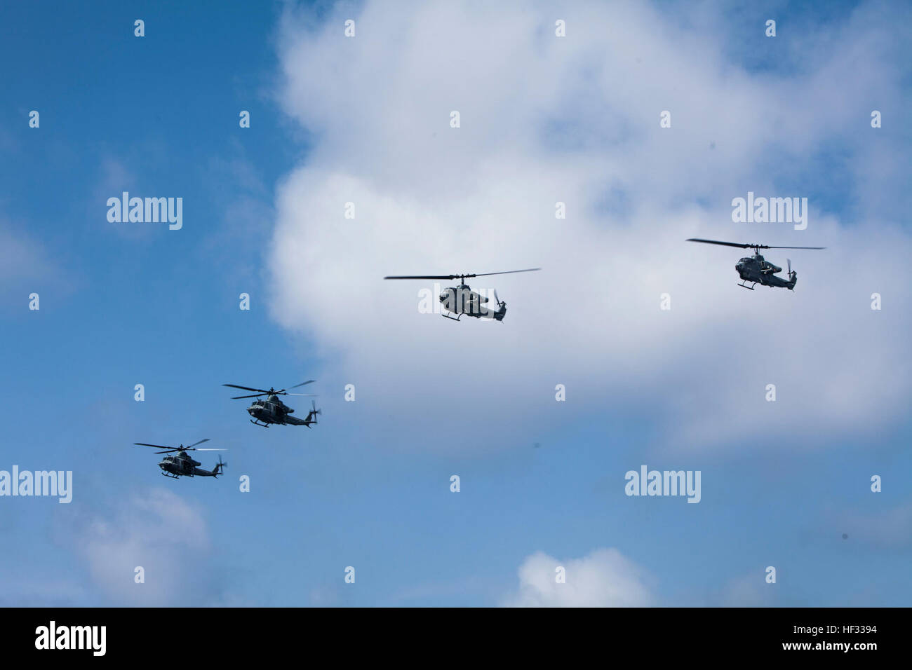 U.S. Marine Corps UH-1Y Hueys and AH-1 Super Cobras assigned to Marine Medium Tiltrotor Squadron 262 (Reinforced), 31st Marine Expeditionary Unit (MEU), fly in formation during a flyover of the USS Green Bay (LPD 20) while out at sea, March 11, 2015. The 31st MEU is currently conducting its Spring Patrol of the Asia-Pacific region. (U.S. Marine Corps photo by GySgt Ismael Pena/Released) VMM 262 (Rein) aboard the USS Green Bay 150314-M-CX588-077 Stock Photo