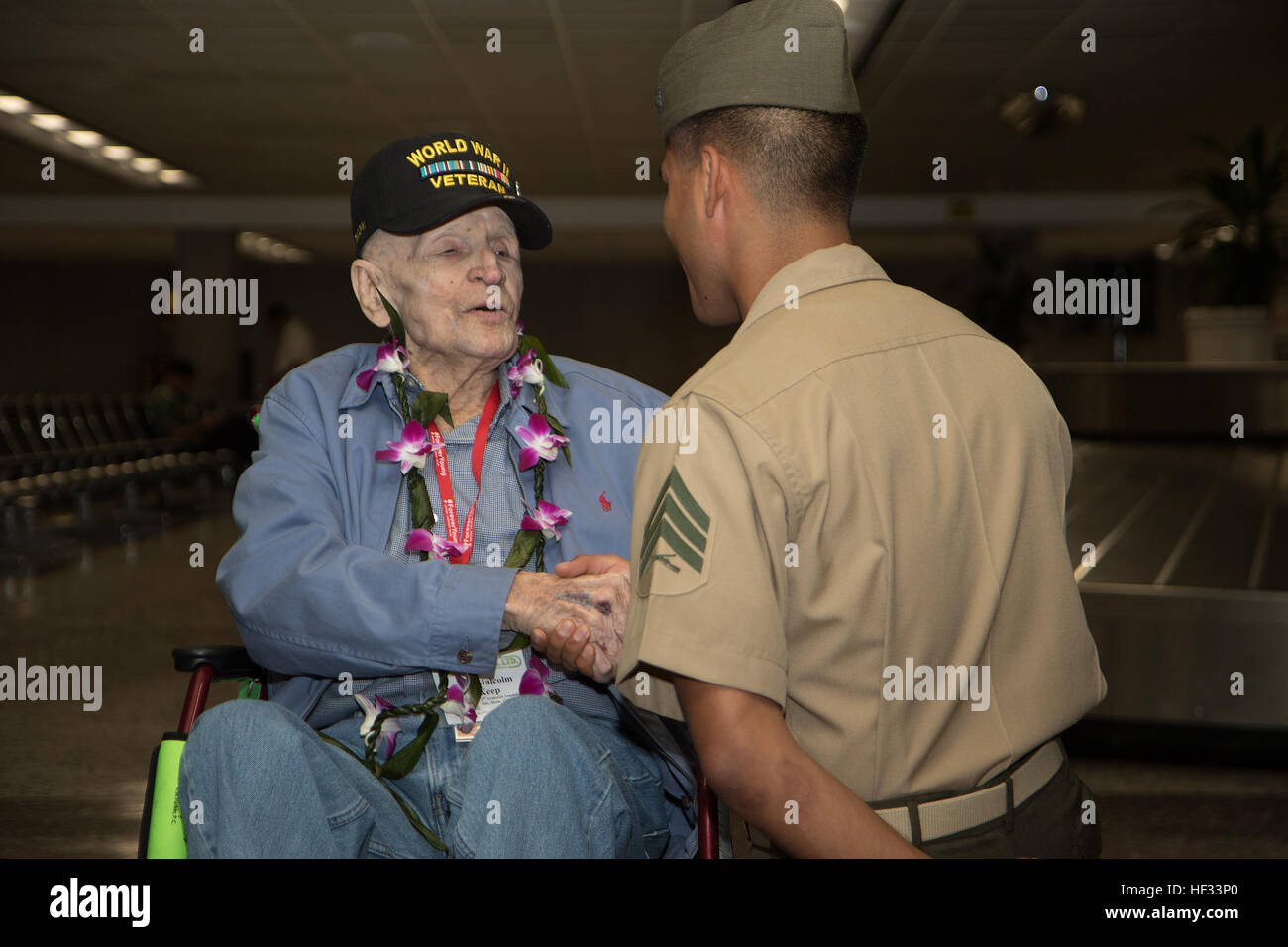 Sgt. Henry Cisneros, a Marine Corps Forces, Pacific property clerk, meets Pfc. Jimmy Keep, a World War II veteran, at the Honolulu International Airport on Oahu, Hawaii, March 17, 2015. Roughly 20 MARFORPAC Marines and a sailor thanked him for his service. Keep is on his way to Iwo Jima for the first time since fighting there as part of the 4th Marine Division 70 years ago. (U.S. Marine Corps photo by Cpl. Matthew J. Bragg) Marines greet WWII vet 150316-M-DP650-016 Stock Photo