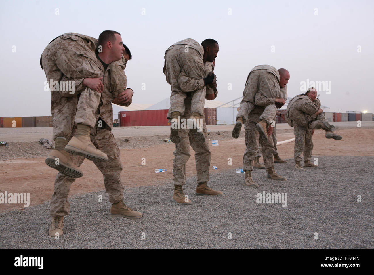 U.S. Marines with Marine Expeditionary Brigade-Afghanistan perform buddy squats during a Marine Corps Martial Arts Program competition at Camp Leatherneck, Afghanistan, July 9, 2009. (DoD photo by Sgt. Evan Barragan, U.S. Marine Corps/Released) 090709-M-4827B-002 (3707619816) Stock Photo