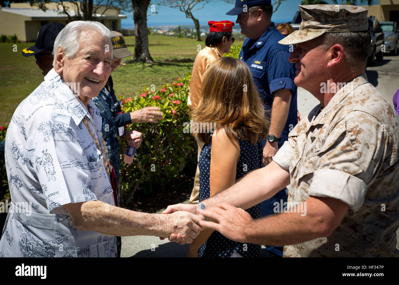 Colonel Philip Zimmerman (right), officer in charge of Marine Corps Activity Guam, greets retired Lt. Gen. Lawrence Snowden during a luncheon at Rear Adm. Bette Bolivar's home for veterans of World War II and other U.S. conflicts. The commander for Joint Region Marianas hosted the veterans at her home on Nimitz Hill for lunch, refreshments and a slice of cake during their island tour visiting war memorials and battle sites. The veterans group then traveled to Iwo Jima, now known officially as Ioto, commemorating the 70th anniversary of the Battle of Iwo Jima. (U.S. Marine Corps photo by Lance  Stock Photo