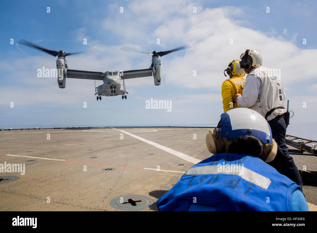 U.S. Navy Sailors guide U.S. Marine pilots with Marine Medium Tiltrotor Squadron 161 (Reinforced), 15th Marine Expeditionary Unit, onto the flight deck of the USS Rushmore (LSD 47) during Composite Training Unit Exercise (COMPTUEX) off the coast of San Diego March 20, 2015. The training prepares pilots and flight crew for similar operations they may encounter while deployed later this spring. (U.S. Marine Corps photo by Sgt. Emmanuel Ramos/Released) Setting Conditions, 15th MEU pilots train for upcoming deployment 150320-M-ST621-427 Stock Photo