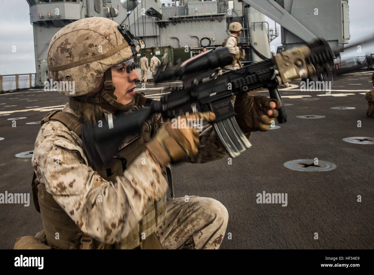 U.S. Marine Lance Cpl. Jaime Camacho gets his Infantry Automatic Rifle back on target after completing a speed reload while practicing squad tactics and maneuver rehearsals aboard the USS Rushmore (LSD 47) during Composite Training Unit Exercise (COMPTUEX) off the coast of San Diego March 20, 2015. Camacho is an automatic rifleman with Kilo Company, Battalion Landing Team 3rd Battalion, 1st Marine Regiment, 15th Marine Expeditionary Unit. The training covered speed reloads and tactical reloads. (U.S. Marine Corps photo by Sgt. Emmanuel Ramos/Released) State of Readiness, 15th MEU Marines build Stock Photo