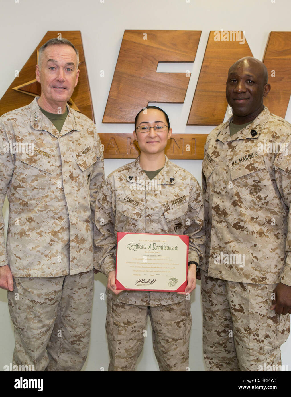 Gen. Joseph Dunford, Commandant of the Marine Corps, and Sgt. Maj. Ronald Green, Sergeant Major of the Marine Corps, pose with Cpl. Guadalupe Campos, a broadcaster with American Forces Network, after her reenlistment during a visit to Marine Corps Air Station Iwakuni, Japan, March 24, 2015. Campos was named Marine Corps Installations Command Marine of the Year for 2014. During their visit, Dunford and Green also conducted an all-hands brief and toured some of the units aboard station including Marine All-Weather Fighter Attack Squadron 242 and Marine Aviation Logistics Squadron 12. Dunford als Stock Photo