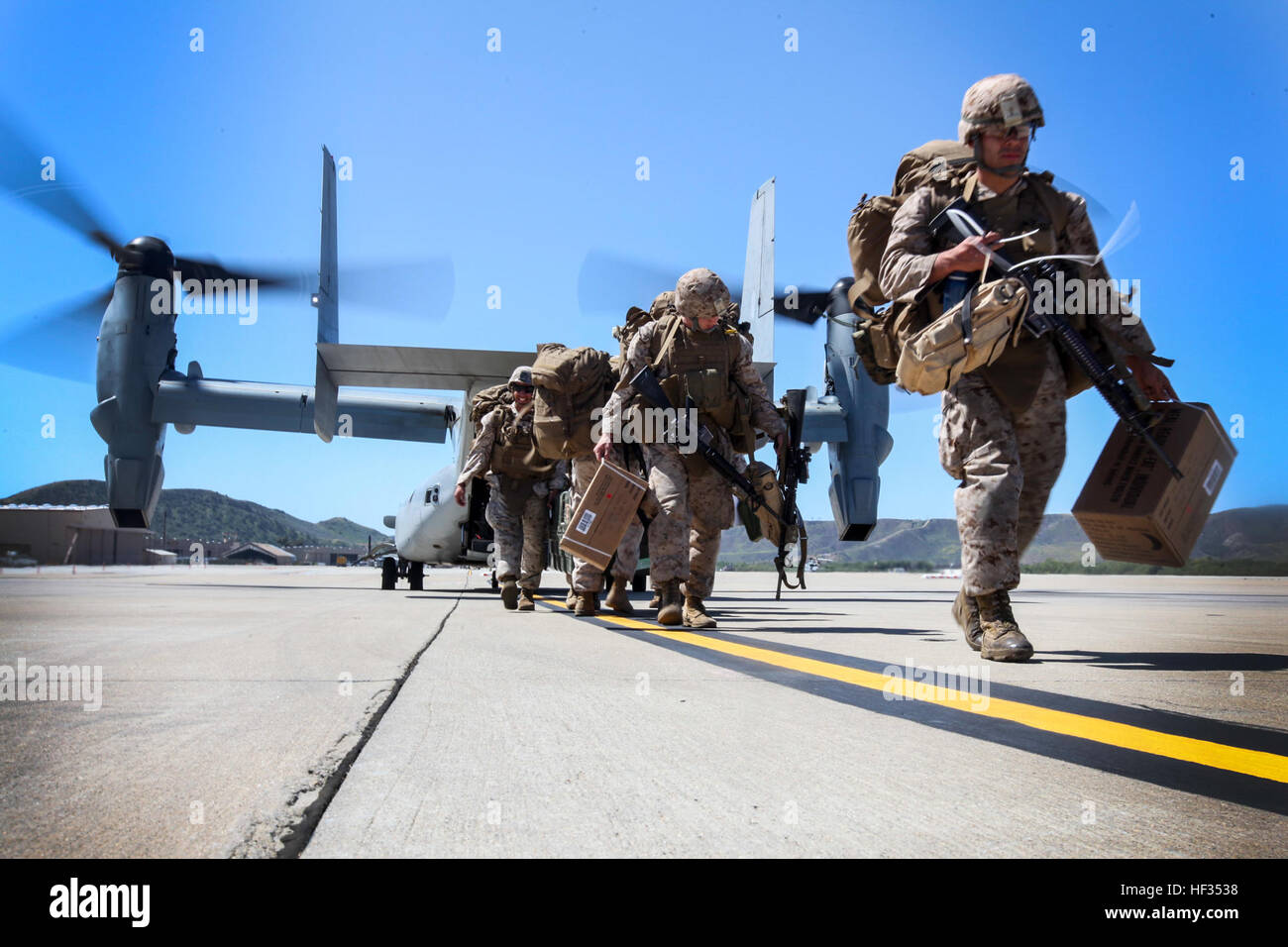 U.S. Marines with Combat Logistics Battalion 15, 15th Marine Expeditionary Unit, step off an MV-22B Osprey during Composite Training Unit Exercise (COMPTUEX) aboard Camp Pendleton, Calif., March 26, 2015. The 15th MEU’s combat logistics element is training to be able to provide humanitarian assistance and engineering support like building Southwest Asia huts for when they deploy in the spring. (U.S. Marine Corps photo by Cpl. Elize McKelvey/Released) 15th MEU prepares for possible humanitarian missions 150327-M-JT438-091 Stock Photo