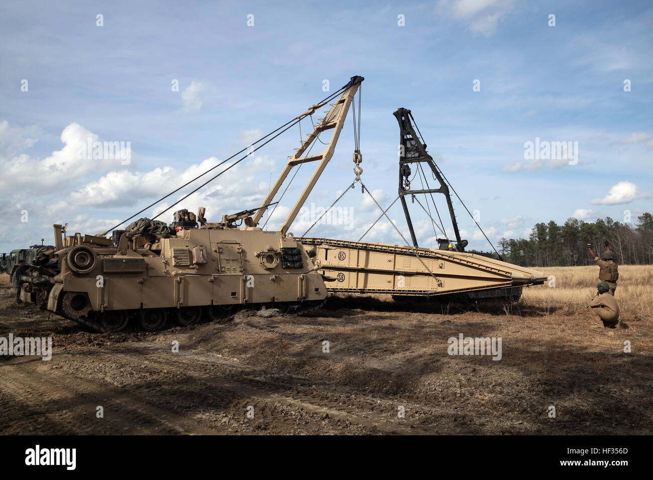 Two M88A2 Heavy Equipment Recovery Combat Utility Lifting Extraction Systems (HERCULES) with 2nd Tank Battalion, 2nd Marine Division lift an M60A1 Armored Vehicle Launched Bridge (AVLB) onto a flatbed for transportation during a Marine Corps Combat Readiness Evaluation at Fort Pickett, Va., March 25-28, 2015. Marines with the battalion were evaluated in different scenarios during the MCCRE, which included tactical road marches, tanks advancing through a field while engaging potential threats, and shooting at a range designed for platoon gunnery qualification.  (U.S. Marine Corps photo taken by Stock Photo