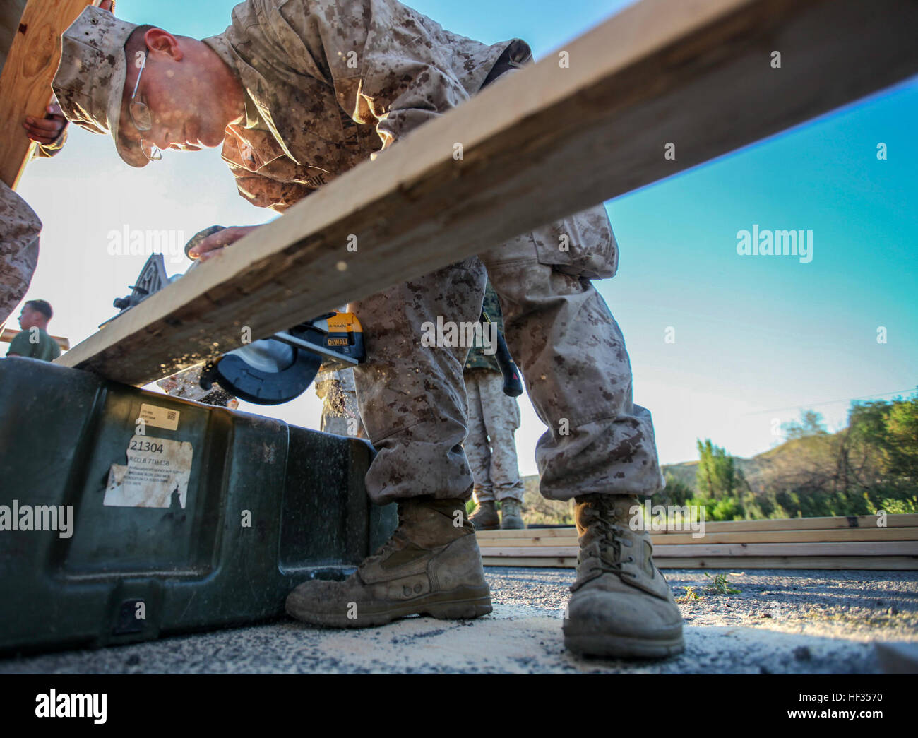 U.S. Marine Lance Cpl. Brandon Larue uses a saw to cut into wood planks to build Southwest Asia huts in support of a simulated Foreign Humanitarian Assistance project during Composite Training Unit Exercise (COMPTUEX) aboard Camp Pendleton, Calif., March 27, 2015. Larue is a combat engineer with the Combat Logistics Battalion 15, 15th Marine Expeditionary Unit. The 15th MEU’s combat logistics element is training to be able to provide humanitarian assistance and engineering support like building SWA huts for when they deploy in the spring. (U.S. Marine Corps photo by Cpl. Elize McKelvey/Release Stock Photo