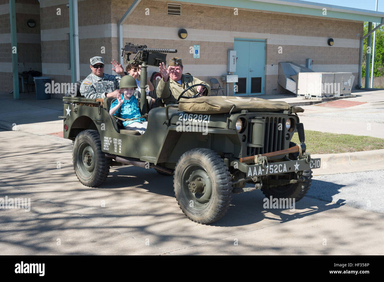 Honorary enlistee Rowan Windham takes a ride on vintage WWII Jeep