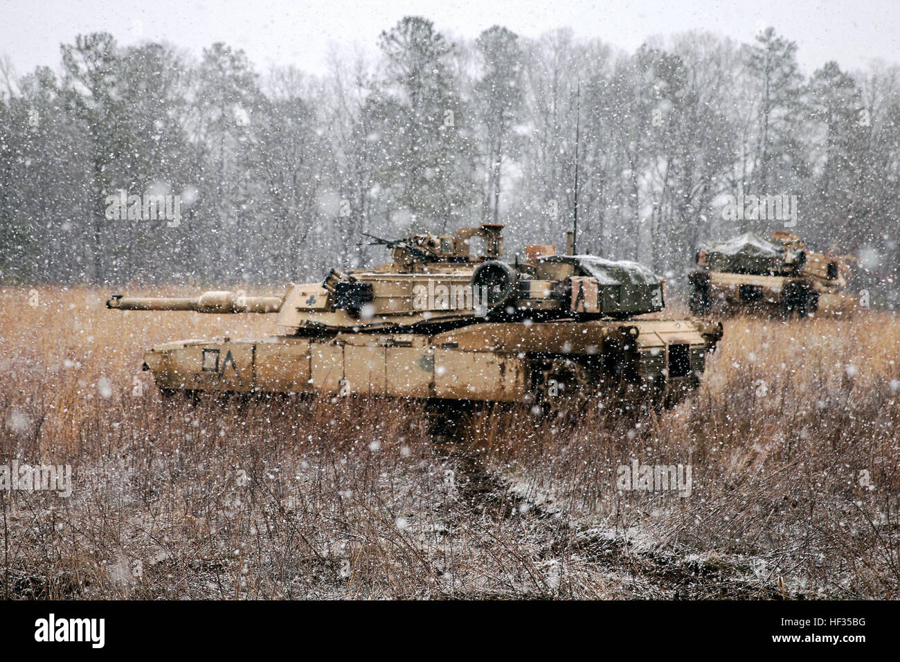 Two M1A1 Abrams with 2nd Tank Battalion, 2nd Marine Division sit on a snowy hill after being gassed during a Marine Corps Combat Readiness Evaluation held at Fort Pickett, Virginia, March 25-28, 2015.  Marines with the battalion were evaluated on different scenarios during the MCCRE, which included tactical road marches, bounding through a field in tanks while engaging potential threats, and shooting at a range designed for platoon gunnery qualification.  (U.S. Marine Corps photo taken by Cpl. Alexander Mitchell/released) Gas gas gas, 2nd Tank Battalion conducts gas attack 150328-M-ML847-127 Stock Photo