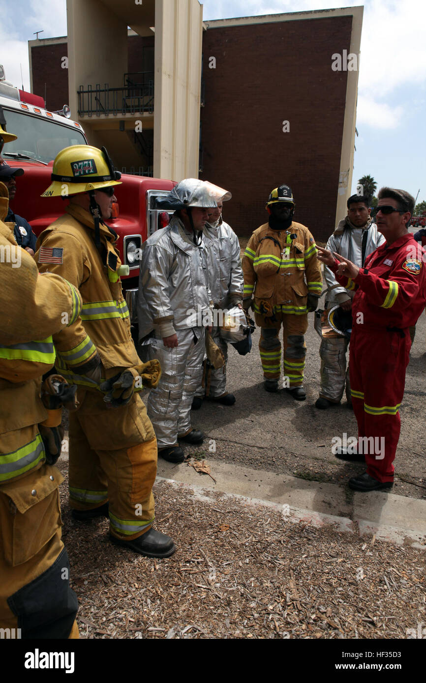 Staley Myers (right), a captain with San Diego Fire Department briefs  Marines and firefighters during a training exercise in San Diego, June 21.  Marine Corps Air Station Miramar Aircraft Rescue and Firefighting