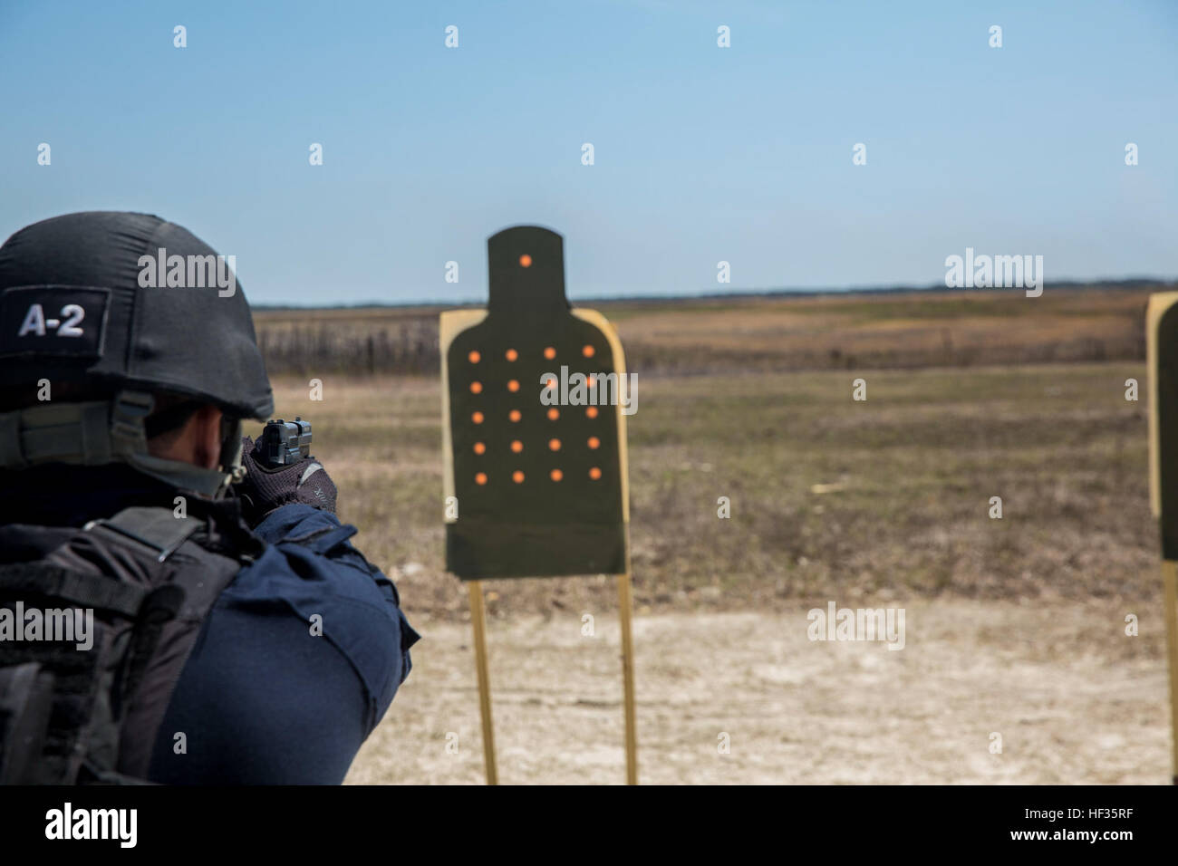 A Deployable Specialized Forces U.S. Coastguardsman fires a .40-caliber personal defense weapon at targets during the Basic Tactical Operations Course aboard Camp Lejeune, N.C., April 2, 2015. BTOC is the baseline course for operators within the Deployable Specialized Forces community and covers the basic fundamentals of marksmanship, shooting while moving, and introductory close-quarters combat training inside of a shoot house. (U.S. Marine Corps photo by Cpl. Shawn Valosin/released) Locked, Loaded, US Coast Guardsmen participate in Advanced Tactical Operations Course 150402-M-IU187-021 Stock Photo