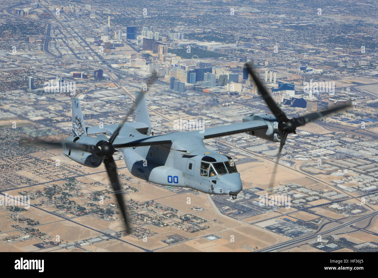 A U.S. Marine Corps MV-22 Osprey tiltrotor aircraft assigned to Marine Medium Tiltrotor Squadron (VMM) 166, Marine Aircraft Group 16, 3rd Marine Aircraft Wing, departs Desert Scimitar 2015 (DS15), flying above Las Vegas, Nevada, April 11, 2015. DS15 is a combined arms exercise that allows units to maintain readiness and meet current and future real-world demands. (U.S. Marine Corps photo by Cpl. Darien J. Bjorndal, 3rd Marine Aircraft Wing/ Released) US Marine Osprey over Las Vegas 140412-M-MF313-146 Stock Photo