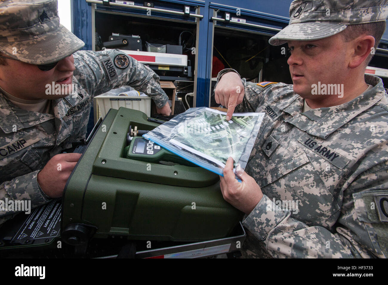 Sgt. William J. Camp Jr., left, and Staff Sgt. Brandon Bottley, both with the 21st Weapons of Mass Destruction Civil Support Team (WMD CST), New Jersey National Guard, examine a satellite photo of a weapons of mass destruction factory site during a full-scale Homeland Response Force exercise involving units from the New Jersey and New York Army and Air National Guard at Joint Base McGuire-Dix-Lakehurst, N.J., April 16, 2015. The Chemical, Biological, Radiological and Nuclear (CBRN) portion of the exercise was performed by National Guard Soldiers and Airmen from New Jersey’s 21st Weapons of Mas Stock Photo
