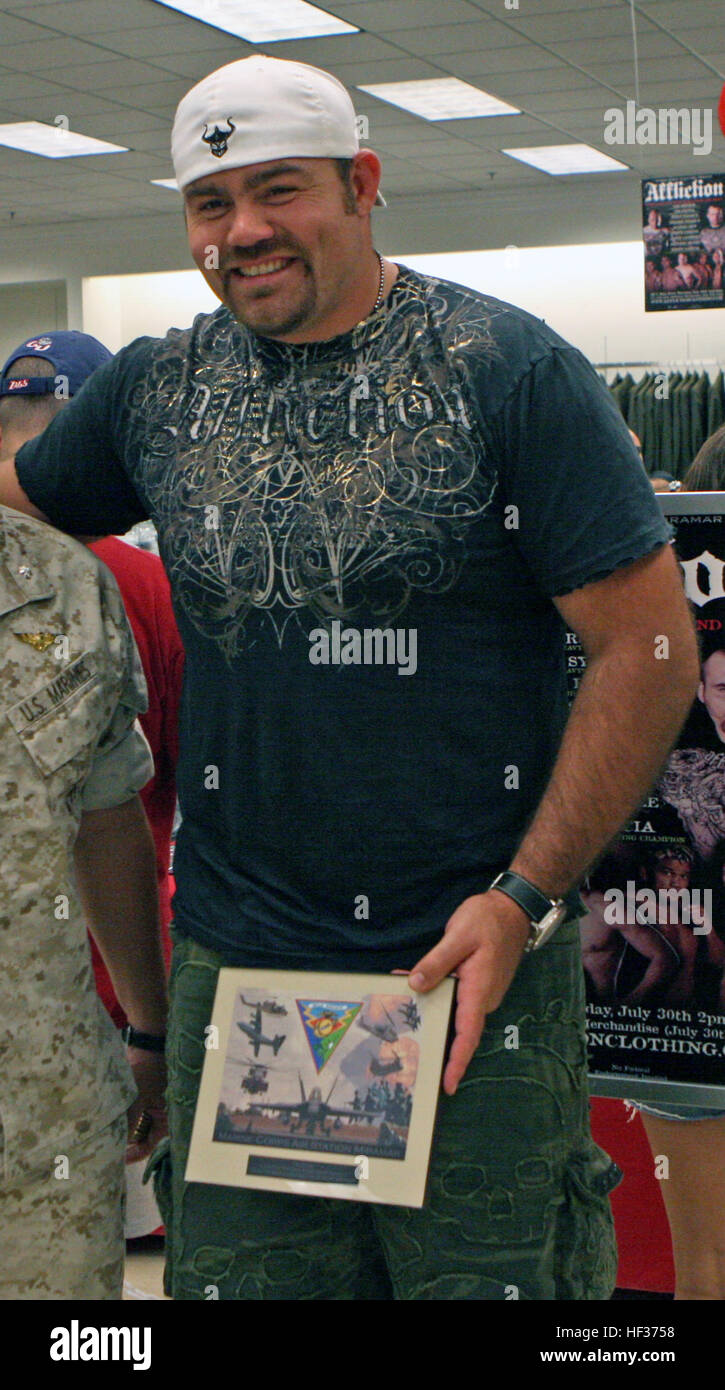 Lt. Col. Steven R. Cusumano, the executive officer of the air station, and Sgt. Maj. Roger E. Jenness, the base sergeant major, presents Tim Sylvia, a former Ultimate Fighting Championship heavyweight with a coin and a plaque from Col. Frank A. Richie, the commanding officer of Marine Corps Air Station Miramar. Affliction clothing company and more than a dozen mixed martial arts fighters visited the exchange on base to meet Marines and sign autographs. Tim Sylvia Stock Photo