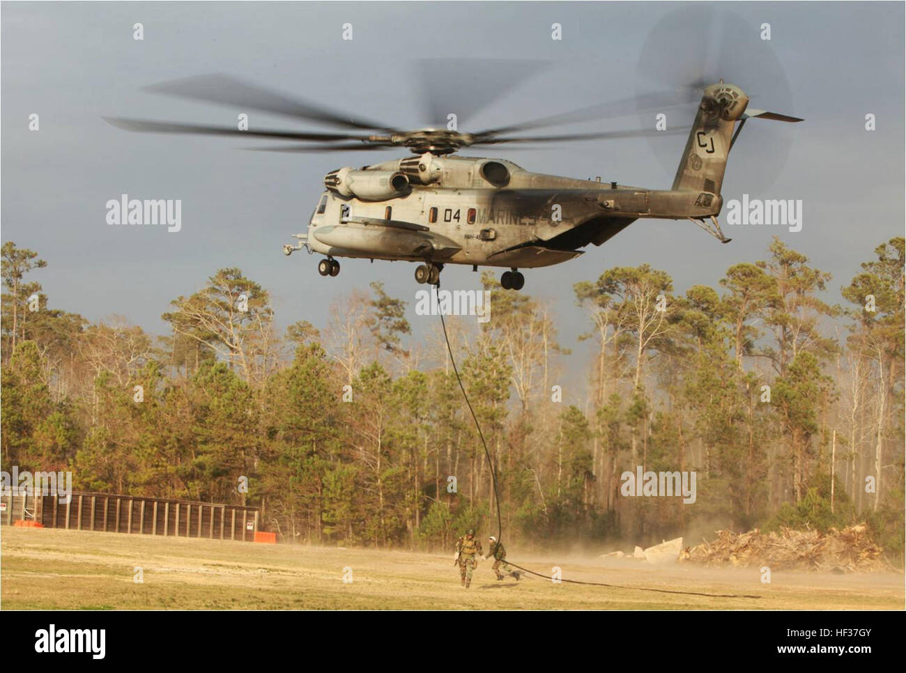 A Royal Dutch Marine fast-ropes from a U.S. Marine Corps CH-53E Super ...