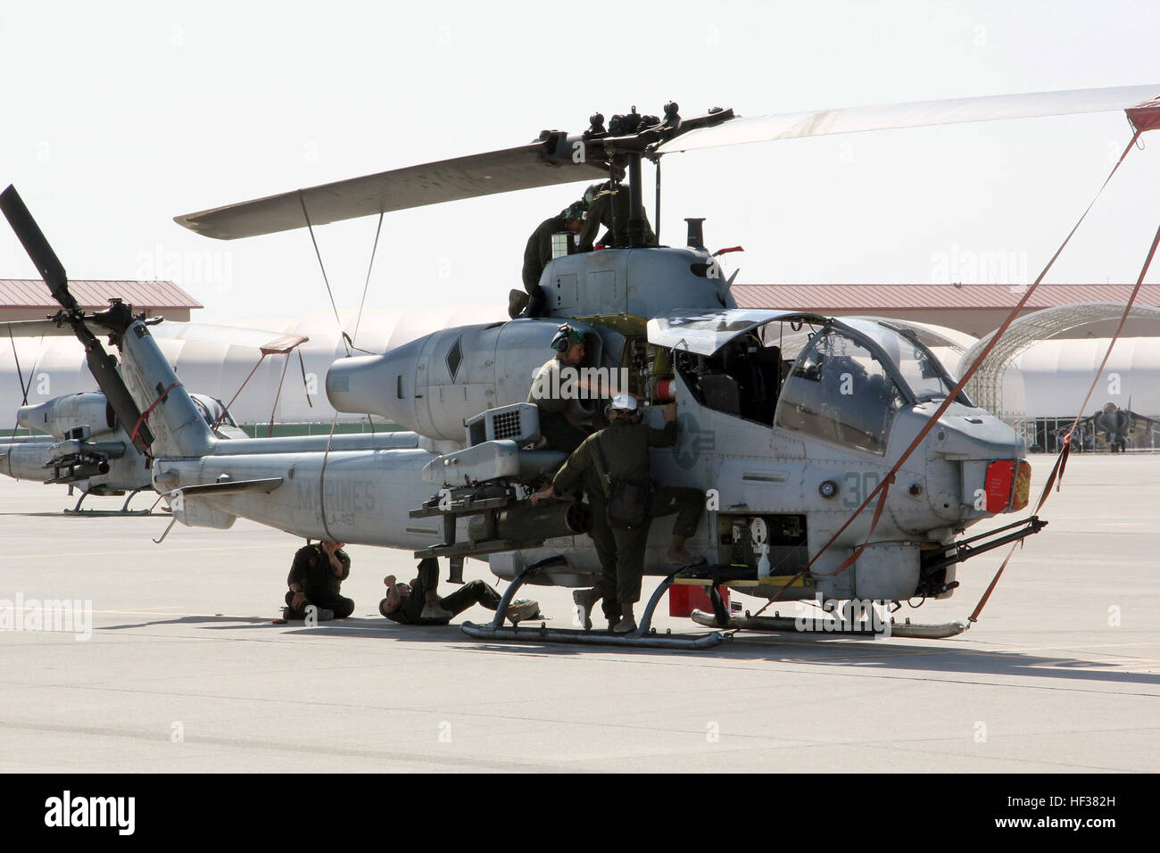 Aircraft mechanic Marines with Marine Aviation Weapons and Tactics Squadron 1 inspect an AH-1W Super Cobra helicopter during a routine maintenance inspection Weapons and Tactics Instructor course 2-15 aboard Marine Corps Air Station Yuma, Ariz., April 22, 2015. The maintenance that they provide ensures all pilot candidates complete every mission safely. WTI is a seven-week course hosted by MAWTS-1 that provides advanced tactical training to certify Marine pilots as weapons and tactics instructors, preparing them to return to the fleet and serve in key training officer billets. (U.S. Marine Cor Stock Photo