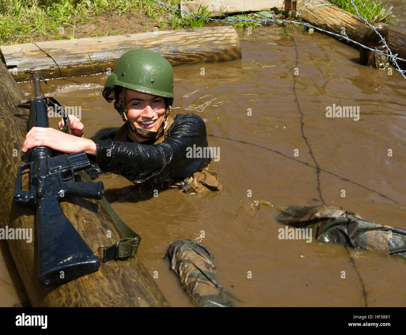 A college student grabs for her rubber rifle while floating in the