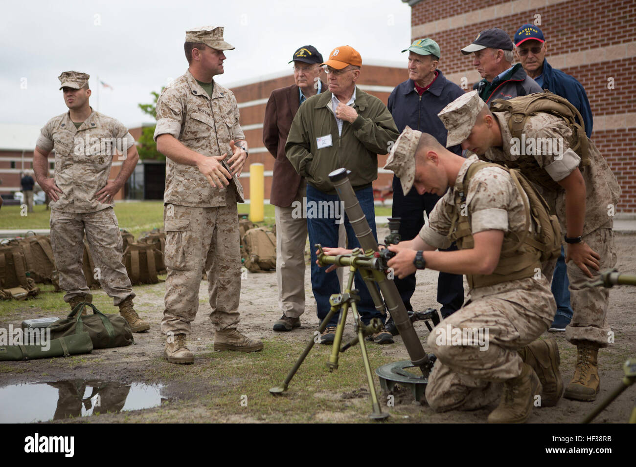 U.S. Marine Corps Veterans observe Infantry Training Battalion (ITB) Marines with Alpha Company, ITB, School of Infantry-East (SOI-East) as they conduct 60mm Mortar training during a scheduled visit on Camp Geiger, N.C., April 30, 2015. Veterans from the Vietnam War visited ITB to see the progression in Infantry Training from when they went through basic Infantry training. (U.S. Marine Corps photo by SOI-East Combat Camera, Lance Cpl. Andrew Kuppers/Released) Vietnam Veterans visit the School of Infantry-East 150430-M-NT768-011 Stock Photo