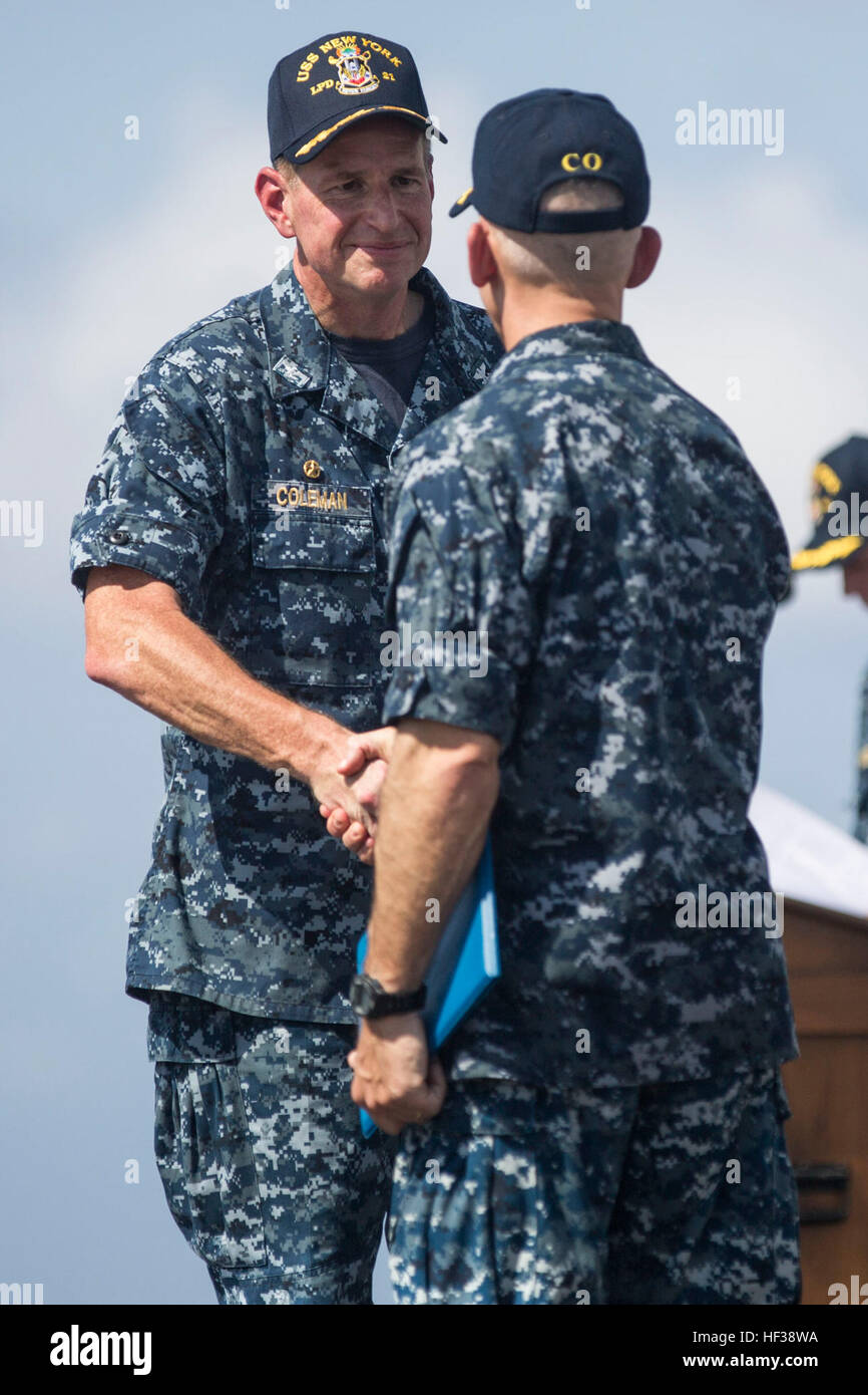 150501-M-YH418-006: GULF OF ADEN (May 1, 2015) - Capt. Kenneth Coleman, commanding officer of the amphibious transport dock ship USS New York (LPD 21), shakes hands with outgoing commanding officer Capt. Christopher Brunett, during a change of command ceremony aboard the USS New York (LPD 21), May 1, 2015. Change of Command Aboard USS New York (LPD 21) 150501-M-YH418-006 Stock Photo