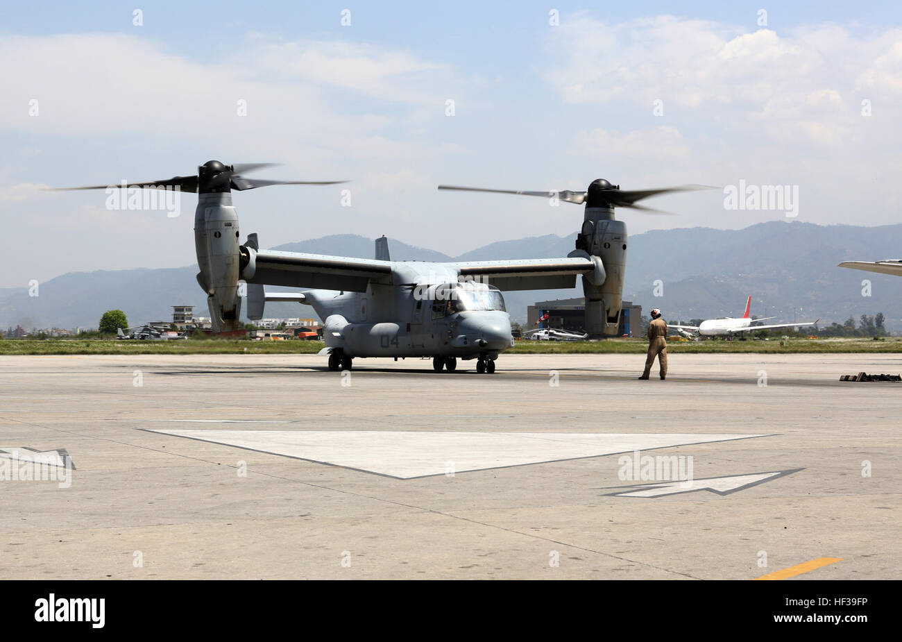 An U.S. Marine Corps MV-22 Osprey sits poised for takeoff on the Kathmandu air strip May 5, 2015. The Nepalese Government requested the U.S. Government’s assistance after a 7.8 magnitude earthquake struck the country, April 25, 2015. U.S. Marines from III Marine Expeditionary Force came together with other U.S. services to form Joint Task Force 505. JTF-505 will work in conjunction with USAID and the international community to provide unique capabilities to assist Nepal. (U.S. Marine Corps photo by MCIPAC Combat Camera CWO3 Clinton Runyon/Released) U.S. Marine Ospreys transport Nepalese milita Stock Photo