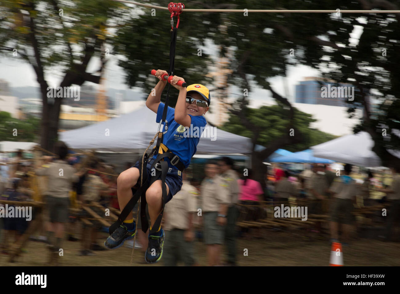 A Cub Scout participates in the Makahiki event, completing rope and ...