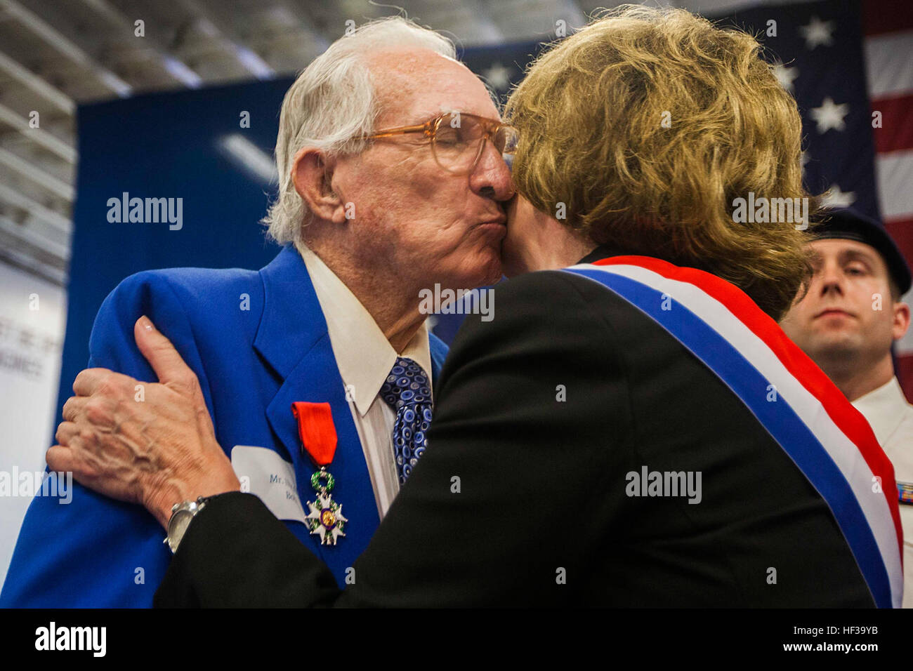 Bob Inman, U.S. Navy World War II veteran, kisses  Jacky Deromedi, France’s senator representing citizens living abroad, after she awarded him the Legion of Honor Medal, France’s highest military honor, for his service in World War II during a ceremony aboard the amphibious assault ship USS Wasp (LHD 1) at Port Everglades, Fla., May 9 for Fleet Week 2015. U.S. Marines and U.S. Navy Sailors of the MEU, from Marine Corps Base Camp Lejeune, N.C., participated in Fleet Week Port Everglades May 4-10. The purpose of Fleet Week was to showcase the strength and capabilities of the Navy and Marine Corp Stock Photo