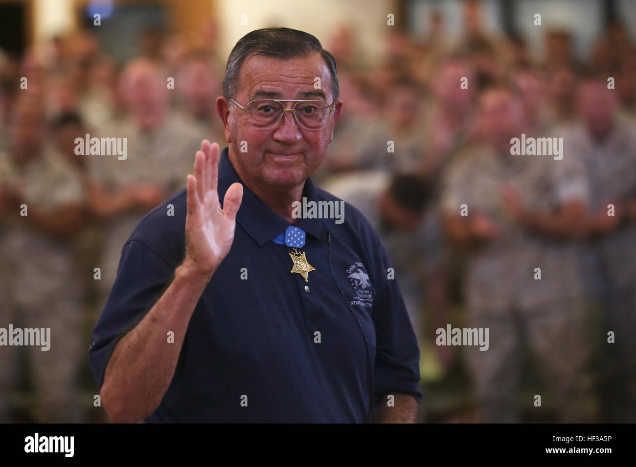 Col. Jay R. Vargas, a Congressional Medal of Honor recipient, waves at the camera after speaking to service members about the importance of finding help for those suffering from post-traumatic stress disorder May 12, 2015, at the Chaplain Joseph W. Estabrook Chapel aboard Marine Corps Base Hawaii. (U.S. Marine Corps photo by Lance Cpl. Harley Thomas/Released) Medal of Honor recipient implores, Let it out 150512-M-SB674-508 Stock Photo