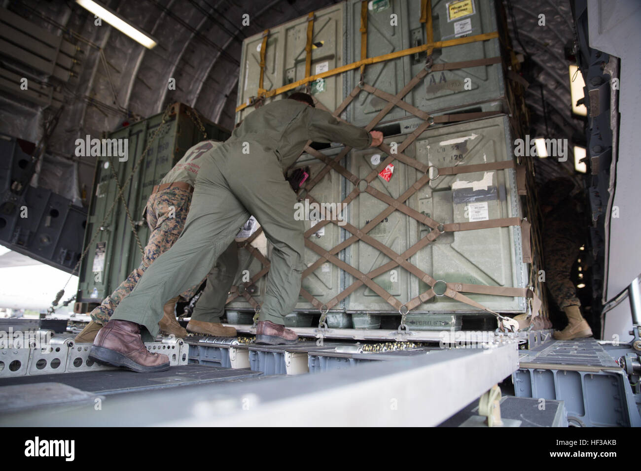 Joint Task Force 505 members load cargo onto a U.S. Air Force C-17 Globemaster III at the Tribhuvan International Airport in Kathmandu, Nepal, May 19. The plane is returning the cargo to Okinawa, Japan, as Operation Sahayogi Haat draws to a close. The U.S. military came together at the request of the government of Nepal and the U.S. Agency for International Development as JTF 505 in response to a 7.8 magnitude earthquake April 25. (U.S. Marine Corps Photo by Cpl. Thor J. Larson/Released) JTF 505 departs Nepal 150519-M-MS007-066 Stock Photo