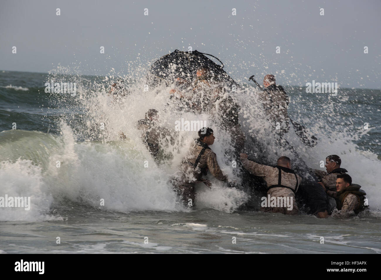 Marines with 3rd Marine Special Operations Battalion, Marine Special Operations Regiment, U.S. Marine Corps Forces, Special Operations Command, make their way through the surf with a combat rubber raiding craft at Onslow Beach, aboard Marine Corps Base Camp Lejeune, N.C., during an amphibious training event, held May 21, 2015. Marines and sailors with the unit participated in a battery of team building exercises featuring small boat tactics, scout swimming and helocasting. (U.S. Marine Corps photo by Cpl. Steven Fox/Released) 3rd MSOB raids Onslow Beach 150521-M-EJ335-002 Stock Photo