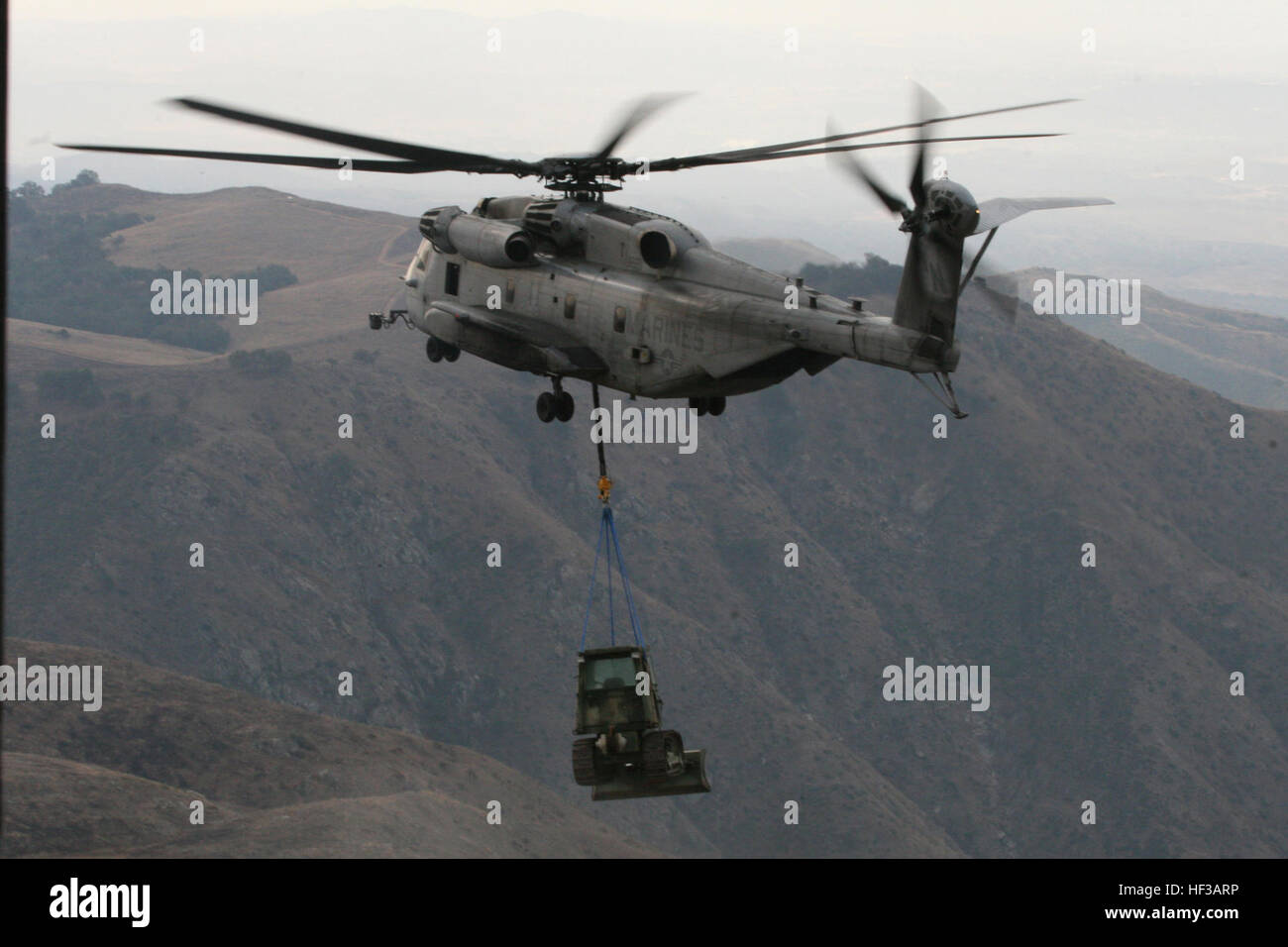 A Marine Heavy Helicopter Squadron 361 CH-53E 'Super Stallion' transports a 25,000 pound bulldozer for 1st Combat Engineer Batallion at Marine Corps Base Camp Pendleton, Calif., as part of a training exercise. USMC-090109-M-5451B-225 Stock Photo