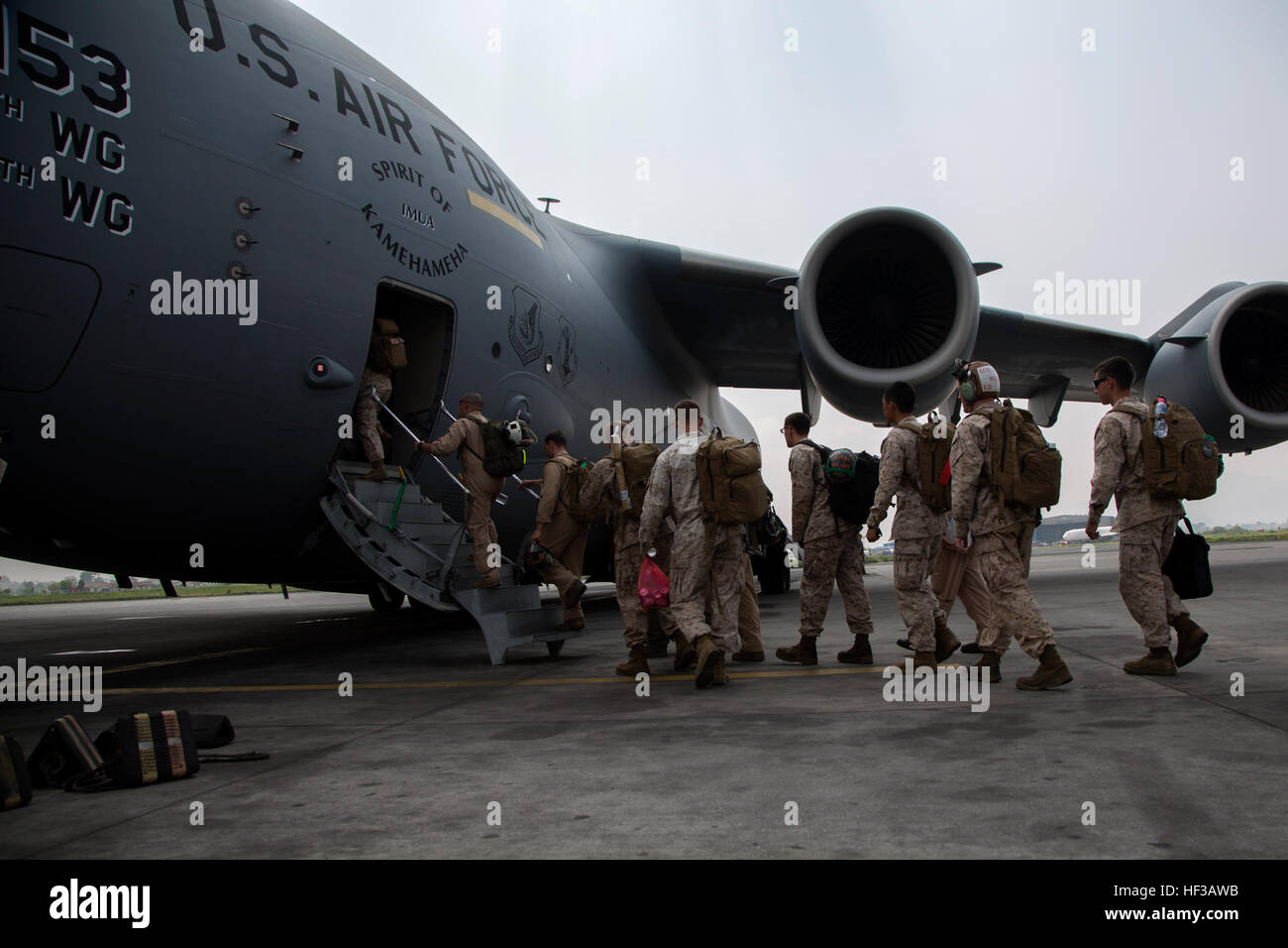 U.S. service members with Joint Task Force 505 board a U.S. Air Force C-17 Globemaster III at Tribhuvan International Airport, Kathmandu, Nepal, May 21 after Operation Sahayogi Haat. JTF 505 along with other multinational forces and humanitarian relief organizations were in Nepal providing aid after a 7.8 magnitude earthquake struck the country, April 25 and a 7.3 earthquake on May 12. At Nepal’s request the U.S. government ordered JTF 505 to provide unique capabilities to assist Nepal. (U.S. Marine Corps photo by MCIPAC Combat Camera Lance Cpl. Hernan Vidana/Released) JTF 505 departs Nepal 15 Stock Photo