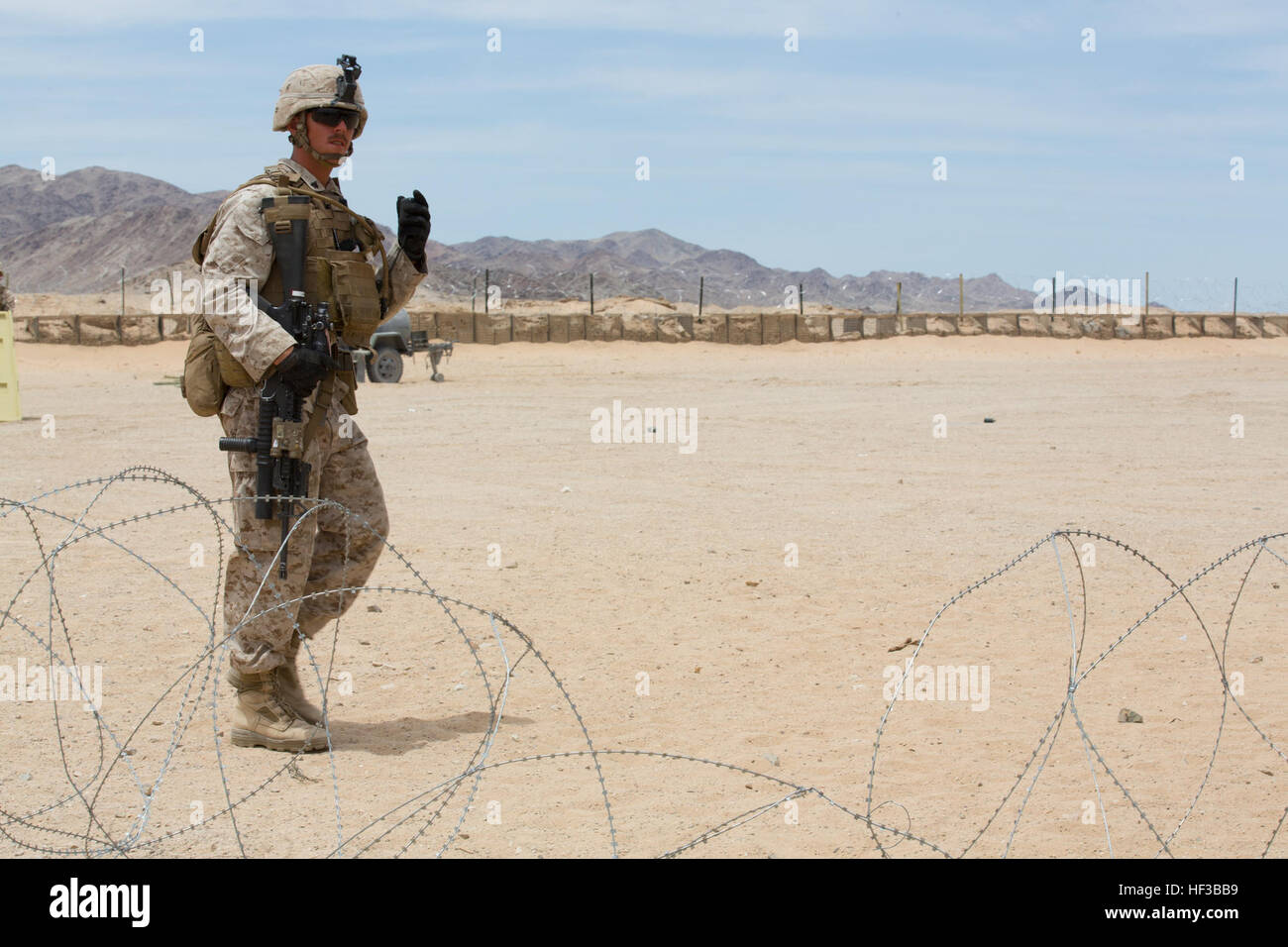A U.S. Marine with Kilo Company, 3rd Battalion, 8th Marines (3/8), conducts an embassy reinforcement during Integrated Training Exercise (ITX) 3-15 aboard Marine Corps Air Ground Combat Center Twentynine Palms, Calif., May 26, 2015. 6th Marines and subordinate units participated in ITX 3-15 to ensure all elements of Special-Purpose Marine Air Ground Task Force 6 (SPMAGTF-6) are prepared for upcoming deployments and operational commitments. (U.S. Marine Corps photo by Staff Sgt. Keonaona C. Paulo 2D MARDIV Combat Camera/Released) ITX 3-15 150526-M-EF955-450 Stock Photo