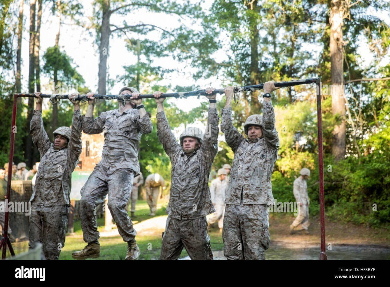 Marines with Electronics Maintenance Company, 2nd Maintenance Battalion, conduct pull-ups during the endurance course at the Battle Skills Training School aboard Camp Lejeune, N.C., May 29, 2015. ELMACO hiked approximately two miles to the school and then conducted the course to build camaraderie and say farewell to their commanding officer, Maj. Brian L. White. (U.S. Marine Corps photo by Cpl. Shawn Valosin) ELMACO conducts hike, completes endurance course 150529-M-IU187-029 Stock Photo