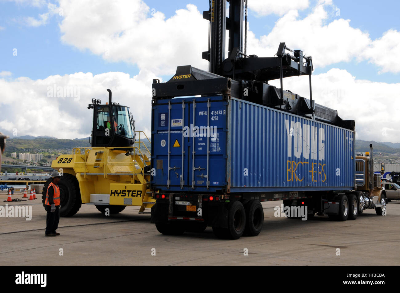 Shipping containers are immediately loaded onto transport vehicles for