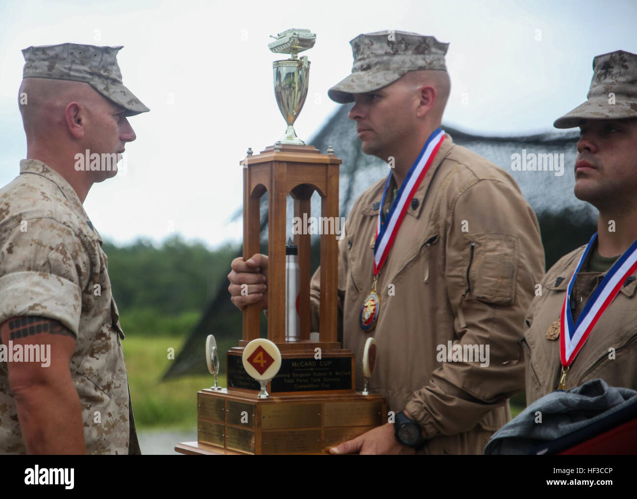 Staff Sgt. Joseph Lowery, a tank commander for 2nd Tank Battalion, and his tank gunner crew, receive the McCard trophy for earning first place in the 13th annual TIGERCOMP aboard Camp Lejeune, N.C., June 5, 2015. The best tank gunner crews from 1st Tank Battalion, 2nd Tank Battalion and 4th Tank Battalion competed for top honors and the McCard trophy bringing the entire tank community, including tank battalion veterans, together for an entertaining display of the tanks force and powerful capabilities. (U.S. Marine Corps photo by Cpl. Michelle Reif/Released.) Marine tankers prove mission readin Stock Photo