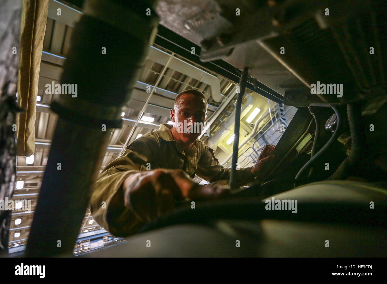 U.S. Marine Lance Cpl. Shane Ledbetter performs vehicle maintenance on a Light Armored Vehicle (LAV-25) aboard the USS Anchorage (LPD 23) in the Philippine Sea, June 5, 2015. Ledbetter is an LAV crewman with 1st Light Armored Reconnaissance Battalion, 15th Marine Expeditionary Unit. The Marines and Sailors of the 15th MEU constantly perform maintenance on their equipment to maintain combat readiness. (U.S. Marine Corps photo by Sgt. Jamean Berry/ Released) U.S. Marines keep vehicles rust free at sea 150605-M-GC438-018 Stock Photo