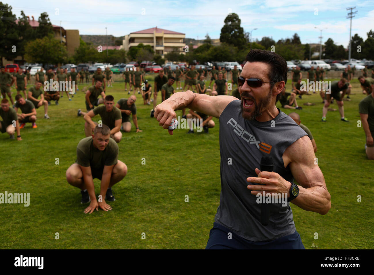 Tony Horton, the creator of P90X, instructs morning physical fitness for the Marines assigned to 3rd Battalion, 5th Marine Regiment, aboard Camp Pendleton, Calif., June 9, 2015. Horton believes Marines need to focus on nutrition and a wide variety of exercises to be ready for any mission as may be directed. Tony Horton, Creator of P90X, visits the Marines and Sailors of Dark Horse 150609-M-VZ995-008 Stock Photo