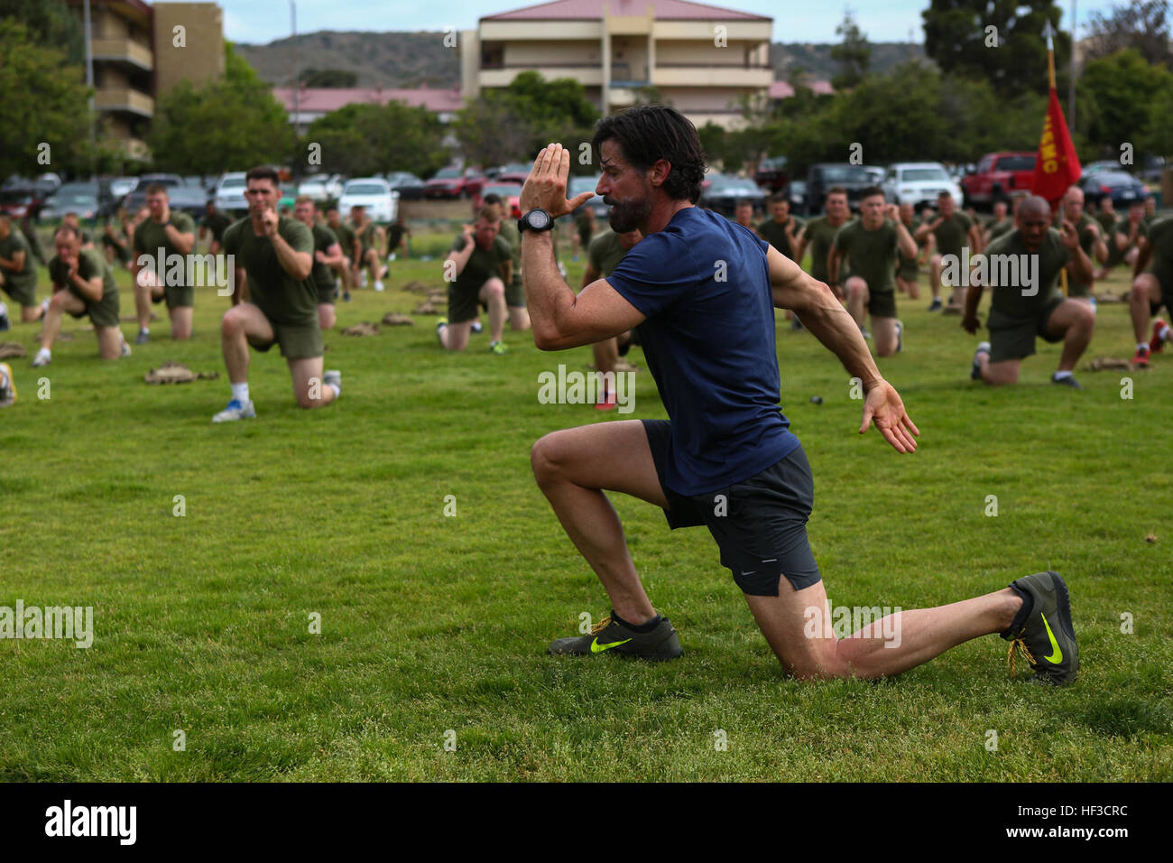 Bobby Stevenson, a trainer with Tony Horton, the creator of the fitness program P90X, demonstrates an exercise for Marines assigned to 3rd Battalion, 5th Marine Regiment, aboard Camp Pendleton, Calif., June 9, 2015. Horton believes Marines need to focus on nutrition and a wide variety of exercises to be ready for any mission as may be directed. Tony Horton, Creator of P90X, visits the Marines and Sailors of Dark Horse 150609-M-VZ995-007 Stock Photo