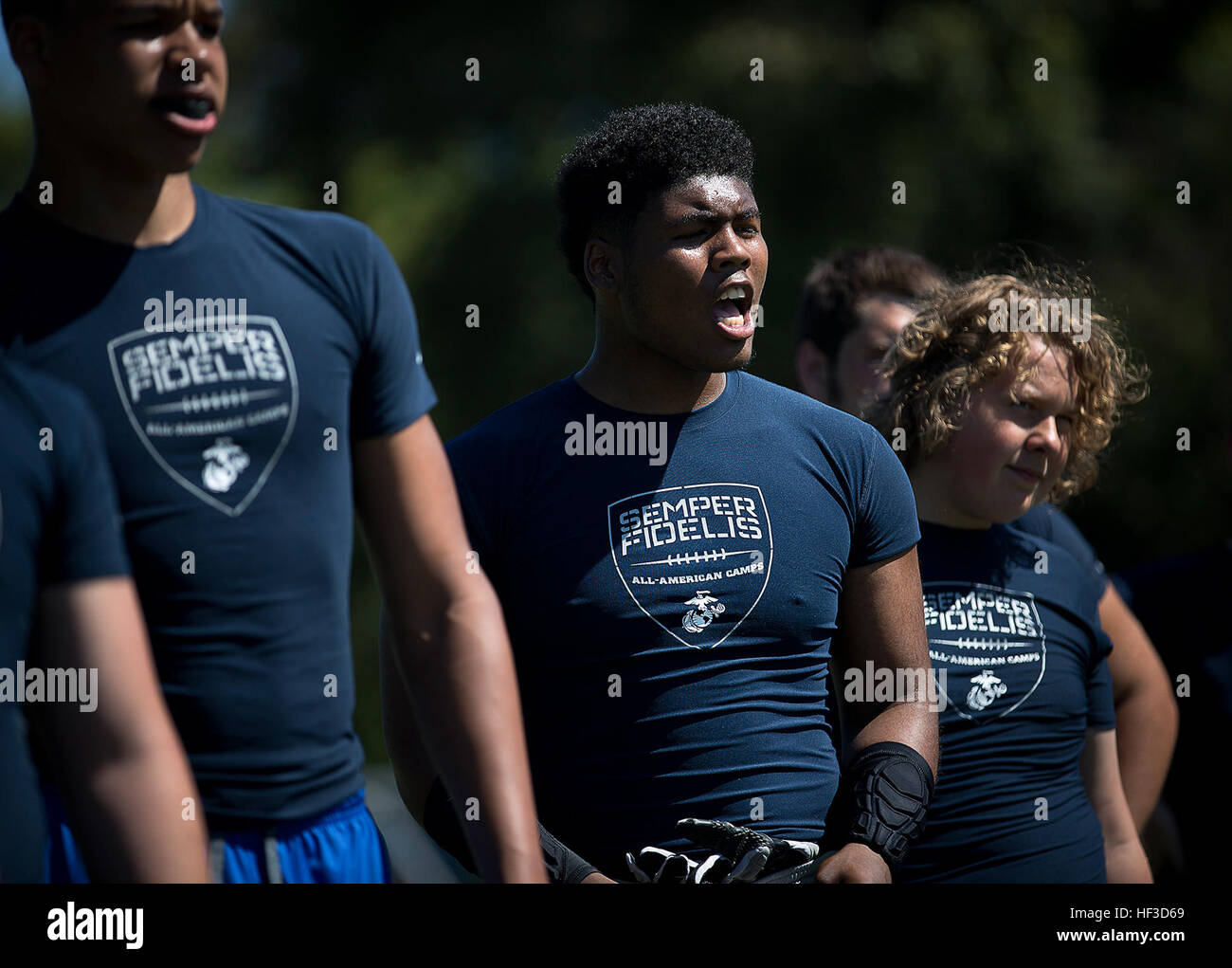 James Hilliard (center), a sophomore at Central Catholic High School, motivates fellow high school football players during a Semper Fidelis All-American football camp at Hazen High School in Renton, Washington, June 14, 2015. More than 160 players from across Washington State experienced the one-day camp, led by former NFL coaches, local high school coaches and Marines. The camp, which focused on leadership and honor both on and off the field, leads up to the Semper Fidelis All-American Bowl game, which will be played in California in January 2016. (U.S. Marine Corps photo by Sgt. Reece Lodder Stock Photo