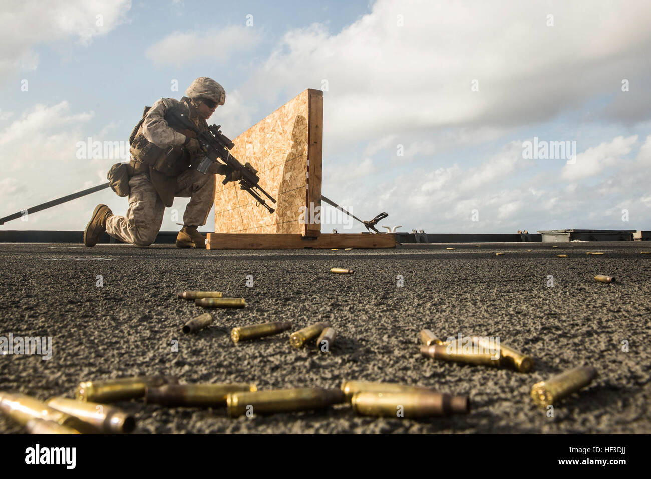 U.S. Marine Lance Cpl. Jose Garcia moves to his next shooting position during a short-range marksmanship qualification course aboard the USS Rushmore (LSD 47) at sea in the Indian Ocean, June 18, 2015. Garcia is a rifleman with Kilo Company, Battalion Landing Team 3rd Battalion, 1st Marine Regiment, 15th Marine Expeditionary Unit. The marksmanship course improves Marine’s combat shooting tactics and prepares them for future operations while deployed with the 15th MEU. (U.S. Marine Corps photo by Sgt. Emmanuel Ramos/Released) U.S. Marines sharpen combat skills at sea 150618-M-ST621-559 Stock Photo