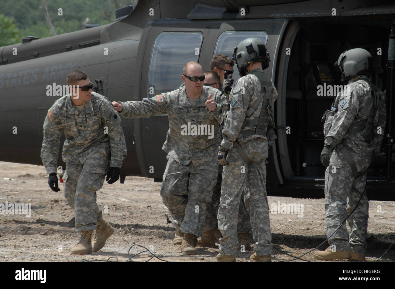 Michigan National Guard Soldiers from 1st Battalion, 125th Infantry Regiment assigned to units in Detroit, Saginaw, Wyoming and Big Rapids practice a UH-60 Black Hawk medical evacuation with 3-238th General Support Aviation Battalion crew during a nuclear detonation response exercise in Grand Rapids, Mich., June 26, 2015. The exercise is called Northern Exposure and is designed to integrate Michigan National Guard members and civilian first responders and rehearse life sustaining capabilities during natural or man-made catastrophic events. For many on the infantrymen, the exercise was the firs Stock Photo