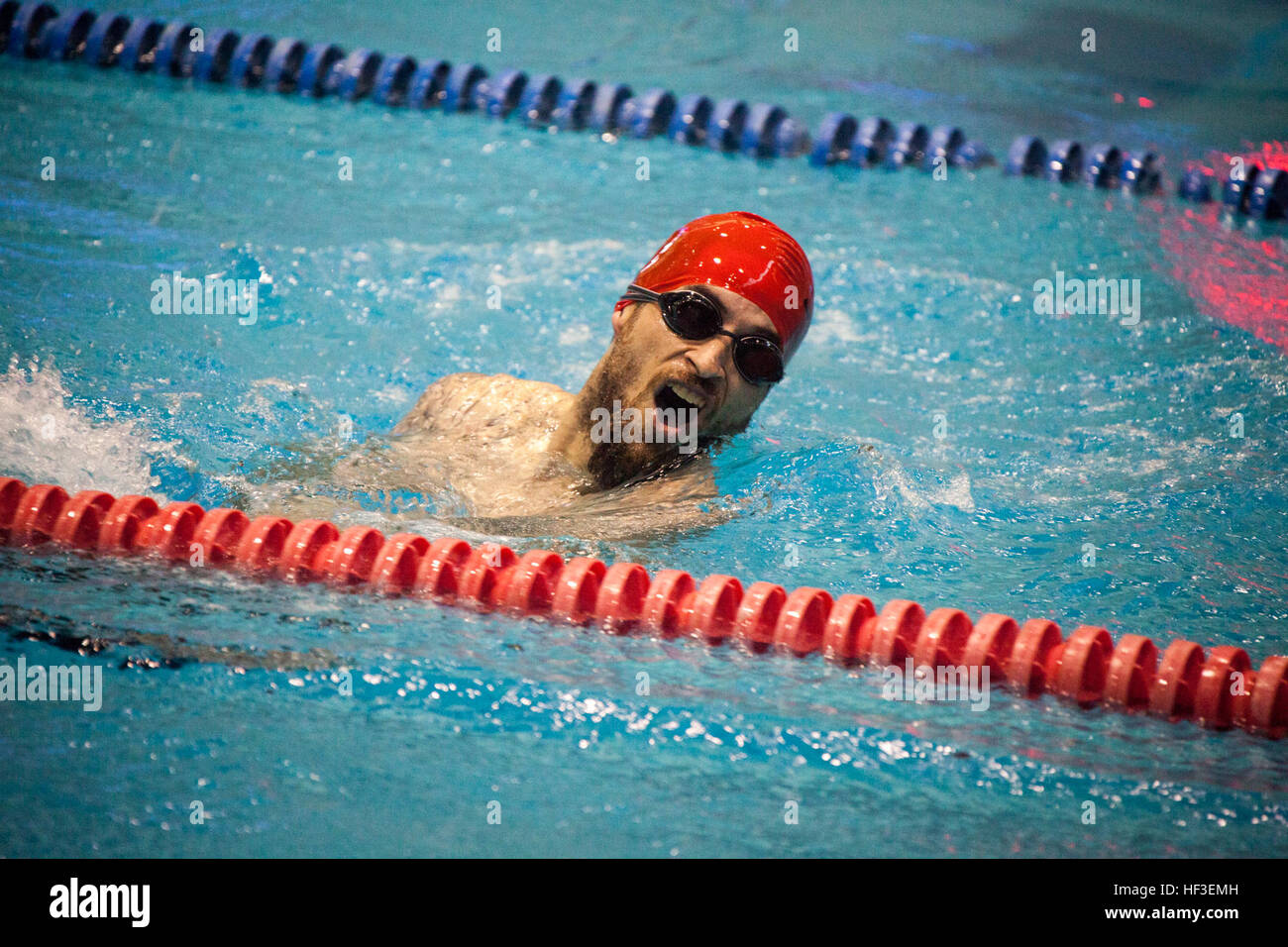 A member of U.S. Marine team competes in the swimming portion of the ...