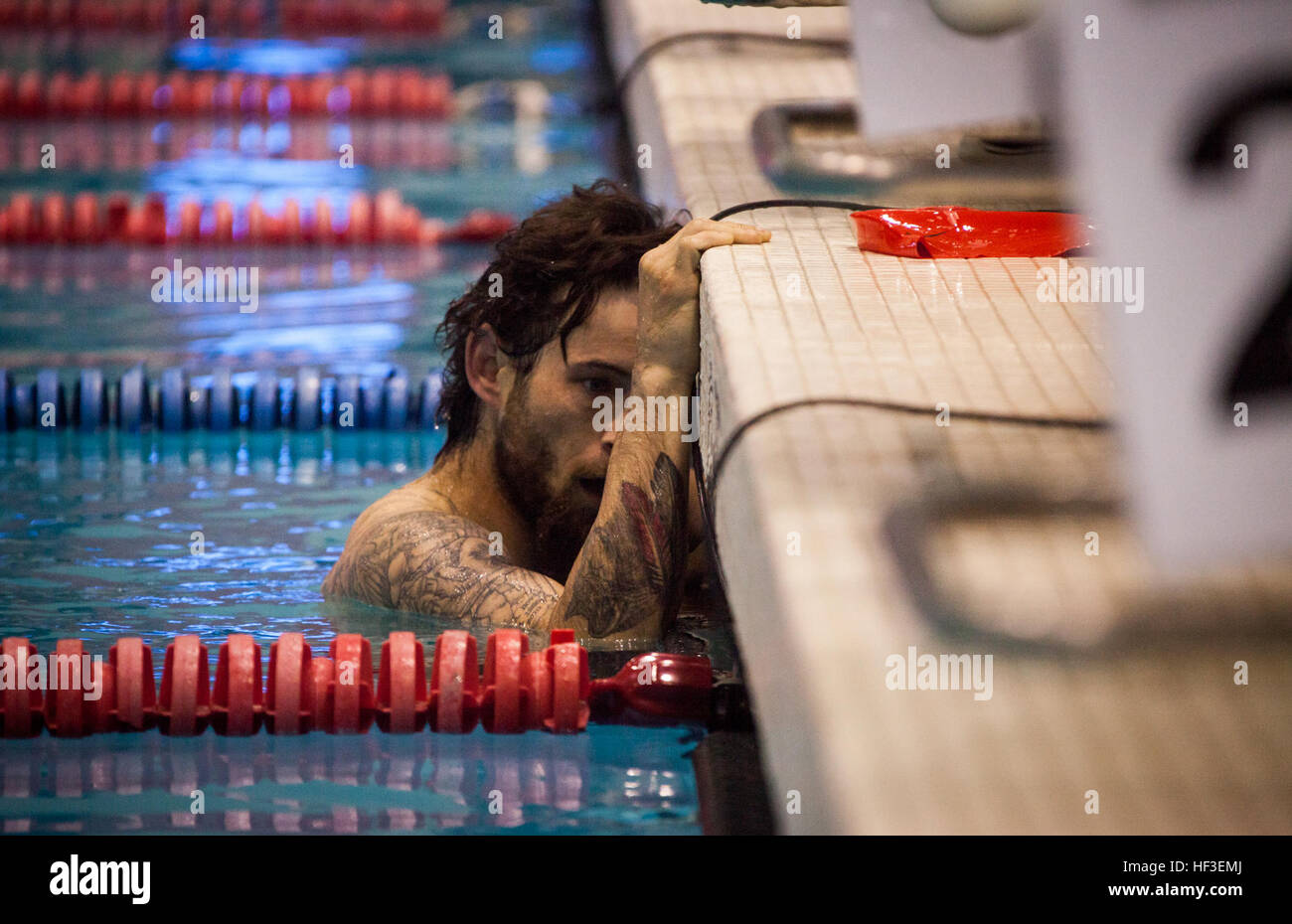 A member of U.S. Marine team competes in the swimming portion of the ...