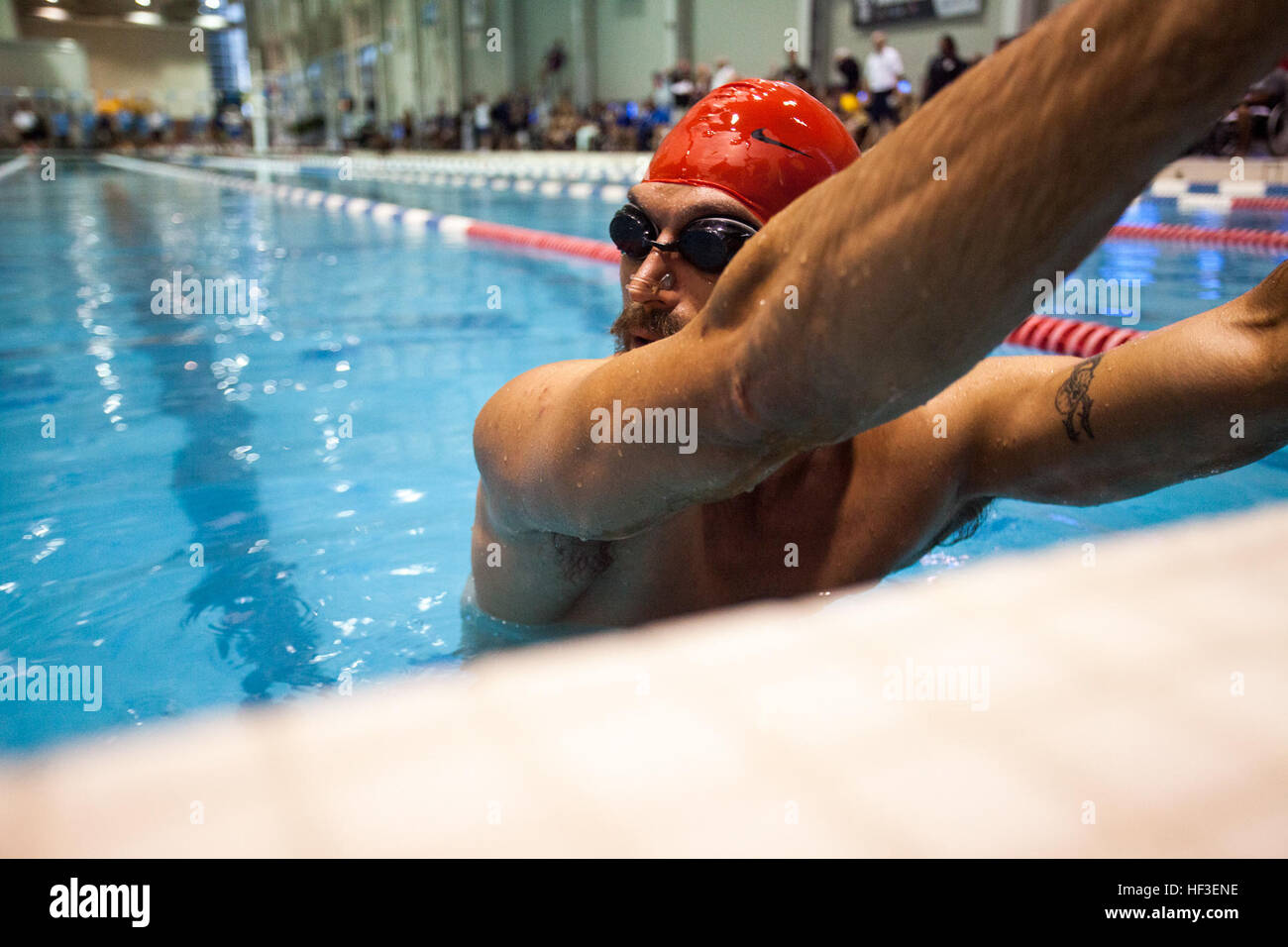 A member of U.S. Marine team competes in the swimming portion of the ...
