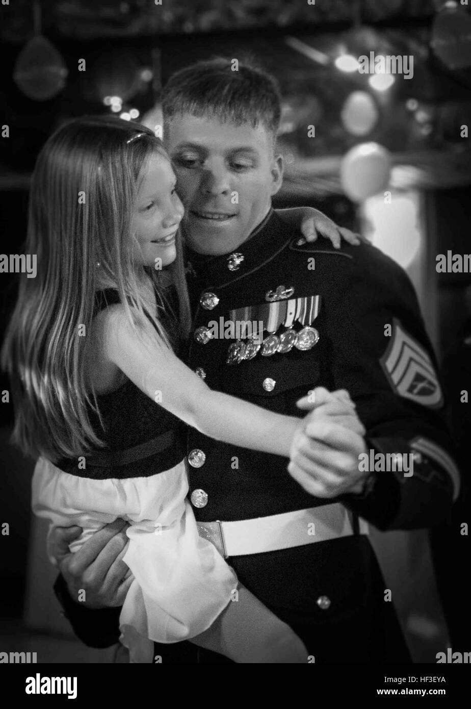 Staff Sgt. Steven Smith shares a moment with his daughter at the Father Daughter Dance hosted by 1st Battalion, 3rd Marine Regiment and the Armed Services YMCA at the Officer's Club, June 27, 2015. The event stressed the importance of a father-daughter relationship and gave them an opportunity to spend quality time together. (U.S. Marine Corps photo by Cpl. Brittney Vito/Released) Daddies, Daughters Dance Night Away 150627-M-TM809-286 Stock Photo