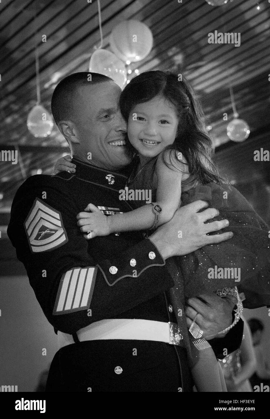Gunnery Sgt. Dustin Peterson and his daughter dance during the Father Daughter Dance   hosted by 1st Battalion, 3rd Marine Regiment and the Armed Services YMCA, at the Officer's Club, June 27, 2015. The event stressed the importance of a father-daughter relationship and gave them an opportunity to spend quality time together. (U.S. Marine Corps photo by Cpl. Brittney Vito/Released) Daddies, Daughters Dance Night Away 150627-M-TM809-931 Stock Photo