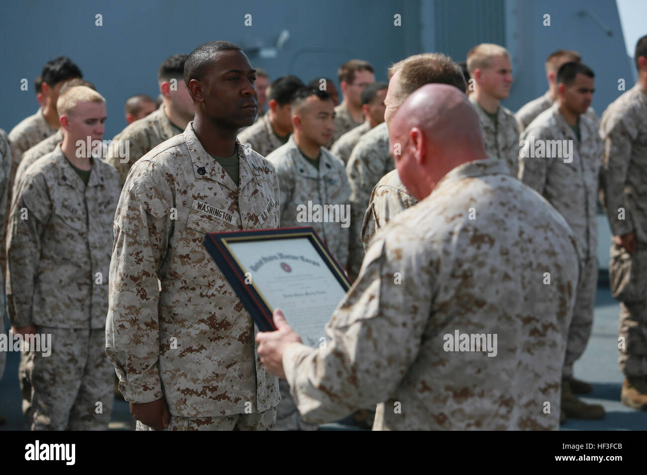 GULF OF ADEN (July 1, 2015) U.S. Marine Gunnery Sgt. Michael Washington, left, reports to Lt. Col. Edward C. Greeley during his promotion ceremony on the forecastle of the amphibious transport dock ship USS Anchorage (LPD 23). Washington is the company gunnery sergeant for Headquarters and Service Company, Battalion Landing Team 3rd Battalion, 1st Marine Regiment, 15th Marine Expeditionary Unit. Anchorage is part of the Essex Amphibious Ready Group and, with the embarked 15th Marine Expeditionary Unit, is deployed in support of maritime security operations and theater security cooperation effo Stock Photo