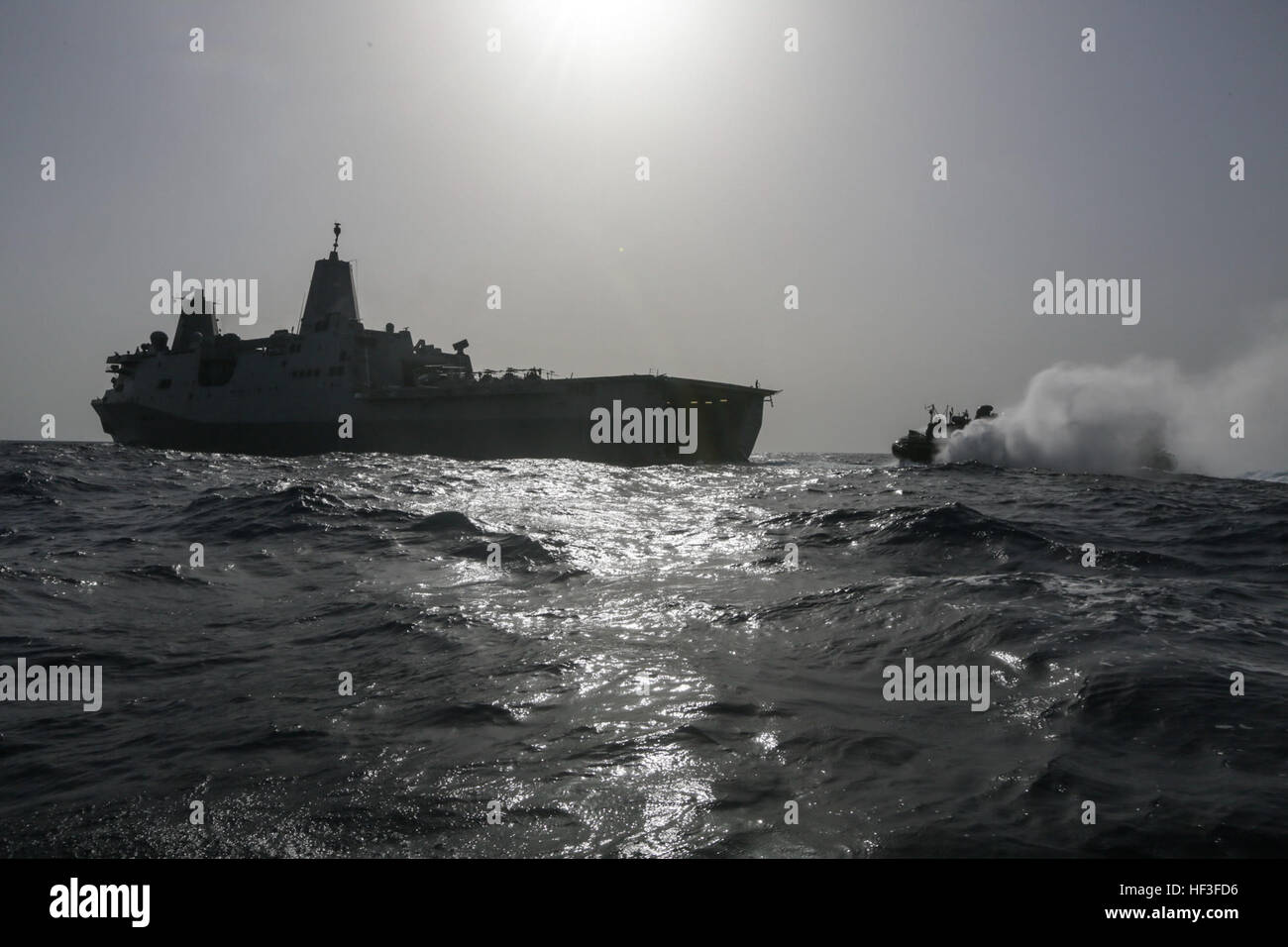 ARABIAN SEA (July 2, 2015) A landing craft, air cushion approaches the stern gate of the amphibious transport dock USS Anchorage (LPD 23). The Anchorage is part of the Essex Amphibious Ready Group and, with the embarked 15th Marine Expeditionary Unit, is deployed in support of maritime security operations and theater security cooperation efforts in the U.S. 5th Fleet area of operations. (U.S. Marine Corps photo by Sgt. Jamean Berry/Released) Anchorage conducts LCAC operations 150702-M-GC438-825 Stock Photo